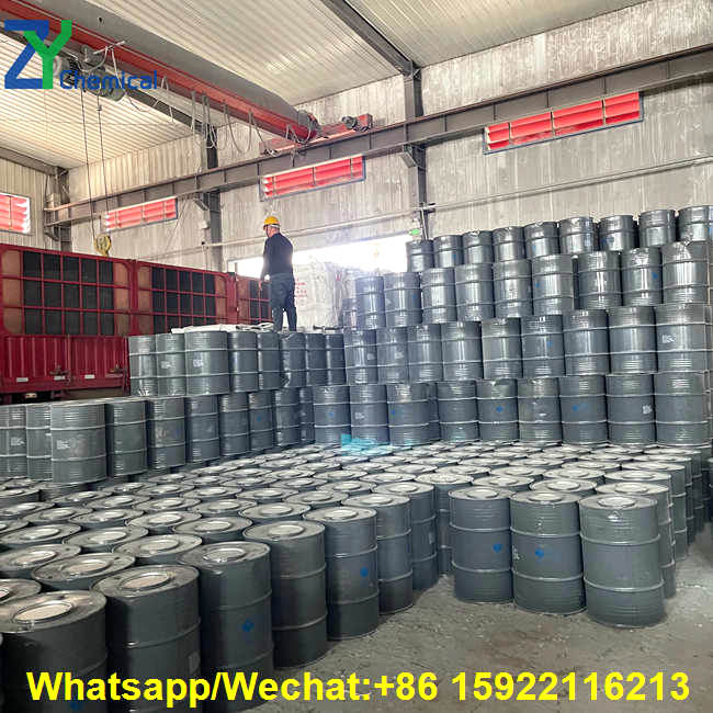 Efficient factory loading of calcium carbide for welding, packed securely in heavy-duty drums to ensure safe international transit.