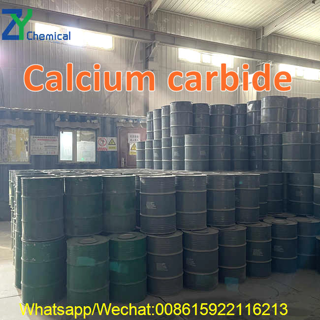 A spacious warehouse facility showcasing neat stacks of green and grey industrial drums packed with high-quality calcium carbide for bulk supply.