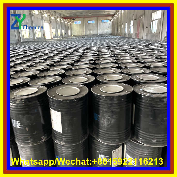 Large inventory of export-grade calcium carbide for sale, securely sealed in standard black steel drums inside our expansive factory warehouse.