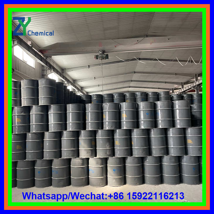 Rows of sealed metal barrels containing calcium carbide lumps neatly stacked inside a large industrial warehouse.