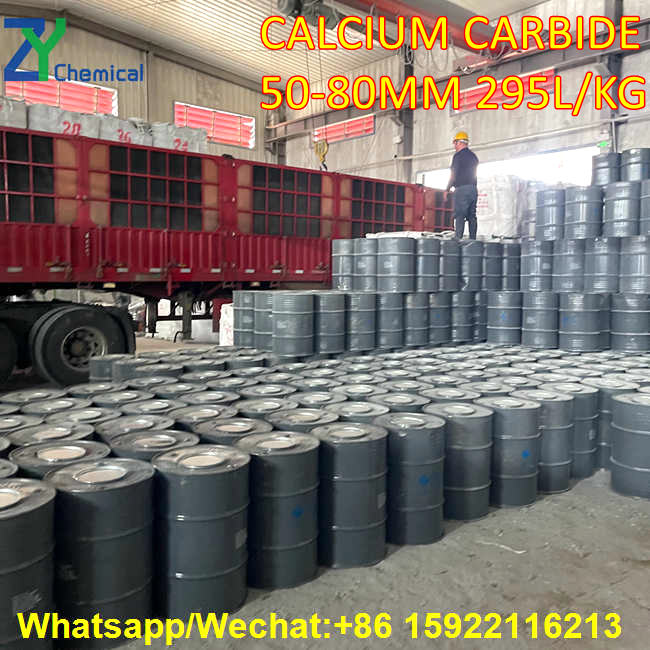 At the calcium carbide supplier's shipping site, personnel are overseeing the loading and preparation for shipment of a large quantity of calcium carbide drums next to a large freight truck.
